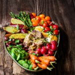 Colourful tuna Nicoise Salad with baby potatoes, cherry tomatoes, olives and eggs.PriMade Food