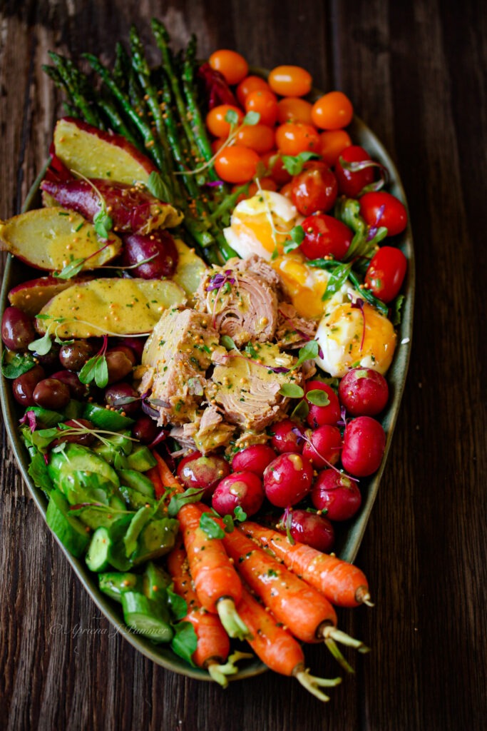 Colourful tuna Nicoise Salad with baby potatoes, cherry tomatoes, olives and eggs. PriMade Food