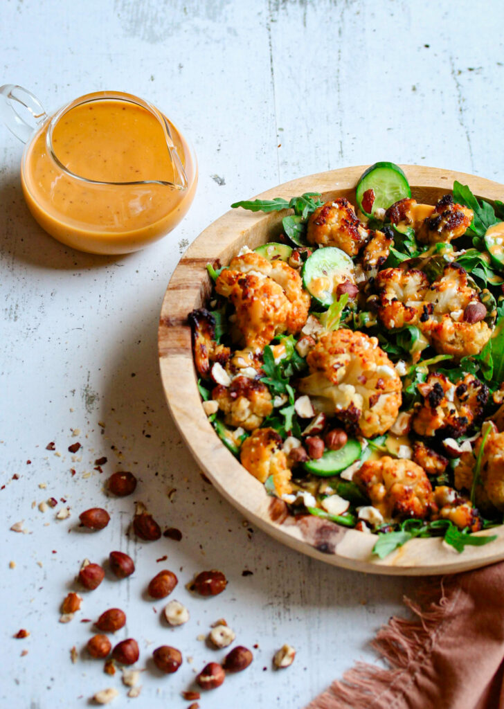 Warm roasted cauliflower salad with toasted hazelnuts and fresh basil