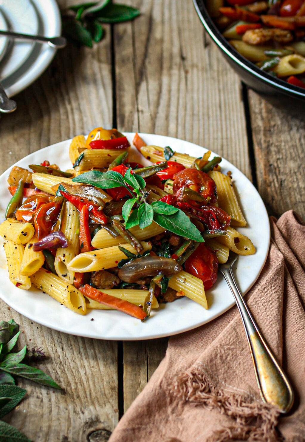 Penne primavera with blistered balsamic tomatoes and fresh basil