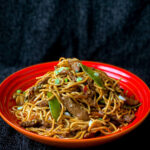Homemade chow mein with egg noodles and colourful stir-fry vegetables