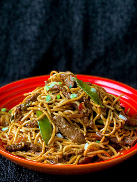 Homemade chow mein with egg noodles and colourful stir-fry vegetables