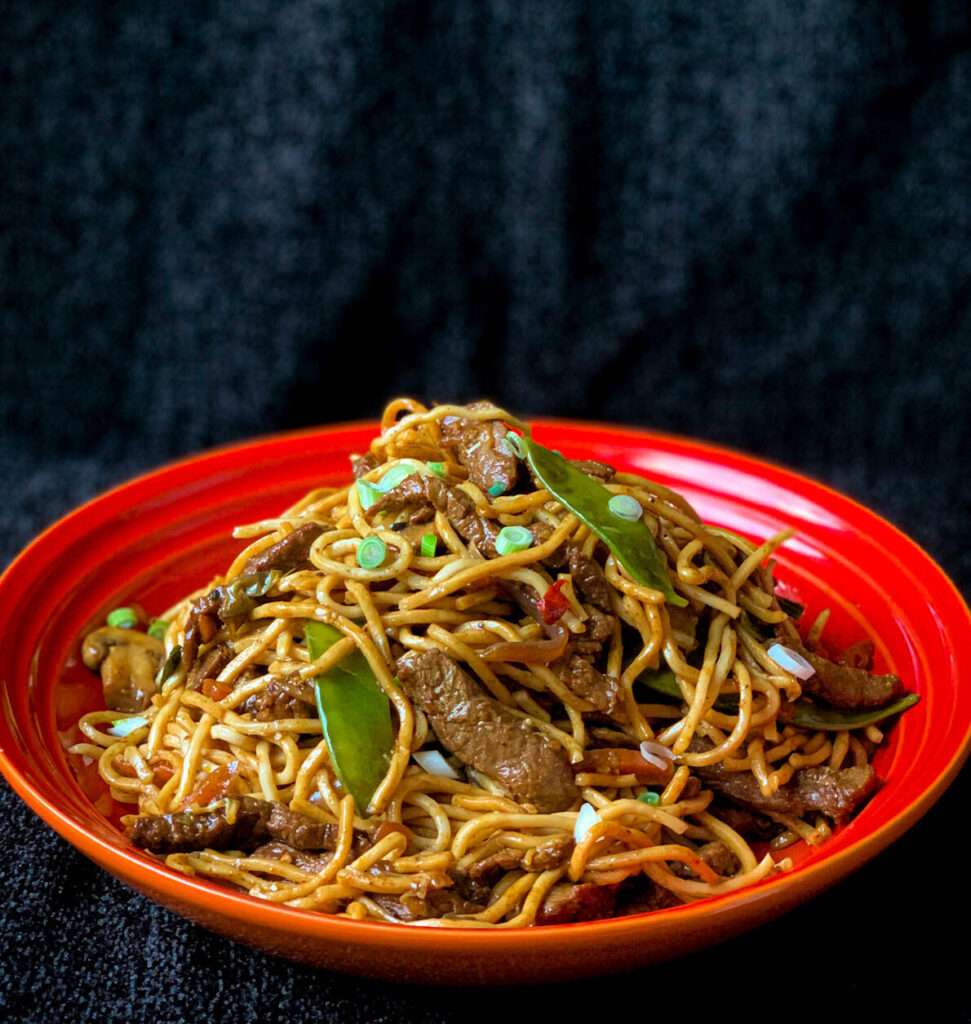 Homemade chow mein with egg noodles and colourful stir-fry vegetables
